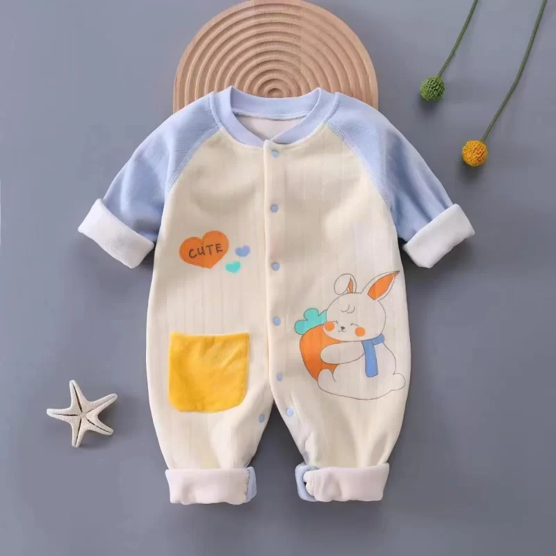 cream-colored baby jumpsuit with light blue sleeves, cuffs, and buttons, featuring a cartoon rabbit and the word 'CUTE' on the front – quality, comfortable, style